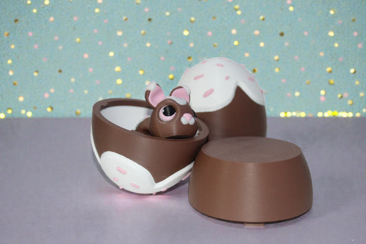 Open chocolate glaze egg container with matching lid beside it and bunny inside, 3D printed PLA collectible spring decor, bunny sold separately.